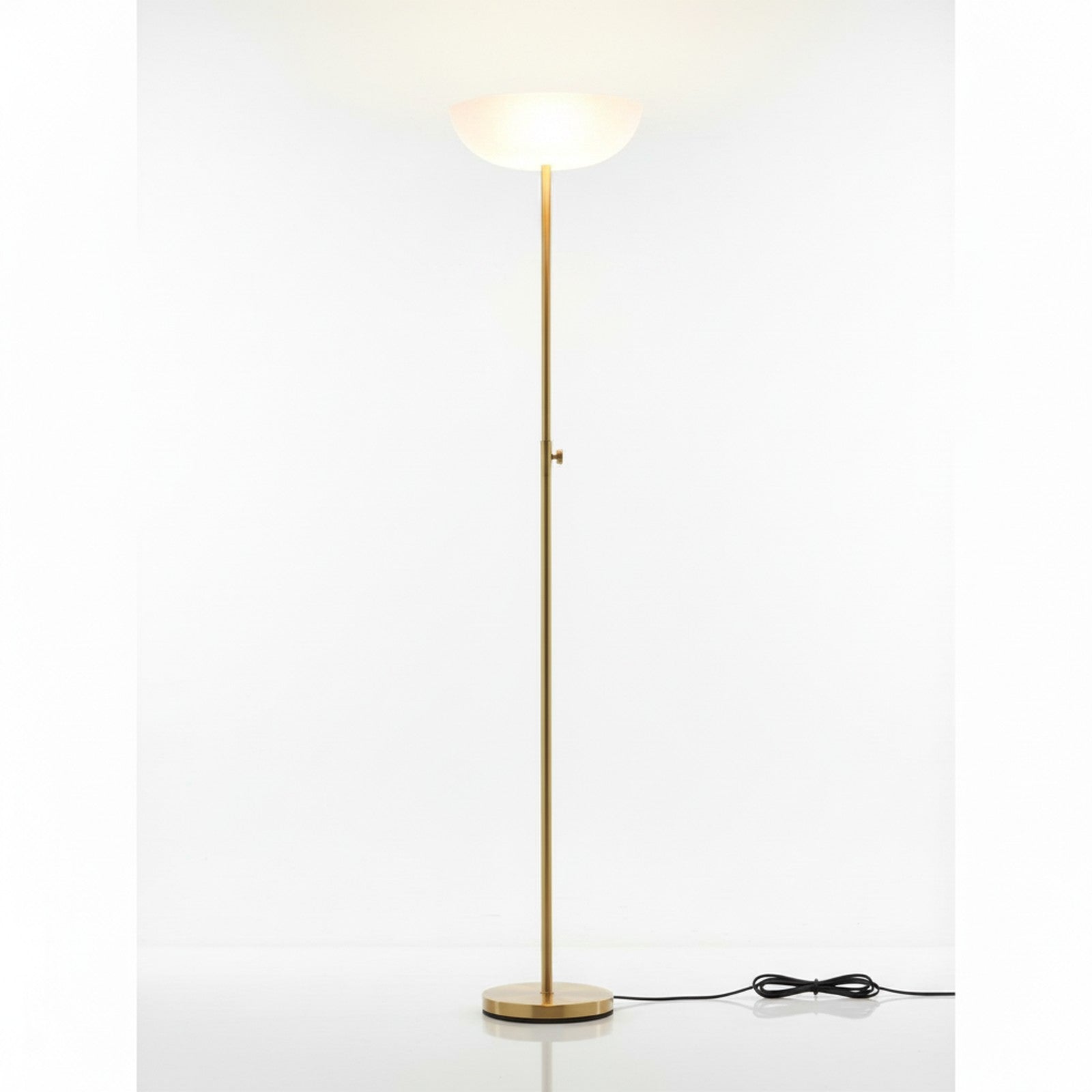 Brass torchiere floor lamp low angle looking up pole to frosted glass bowl shade